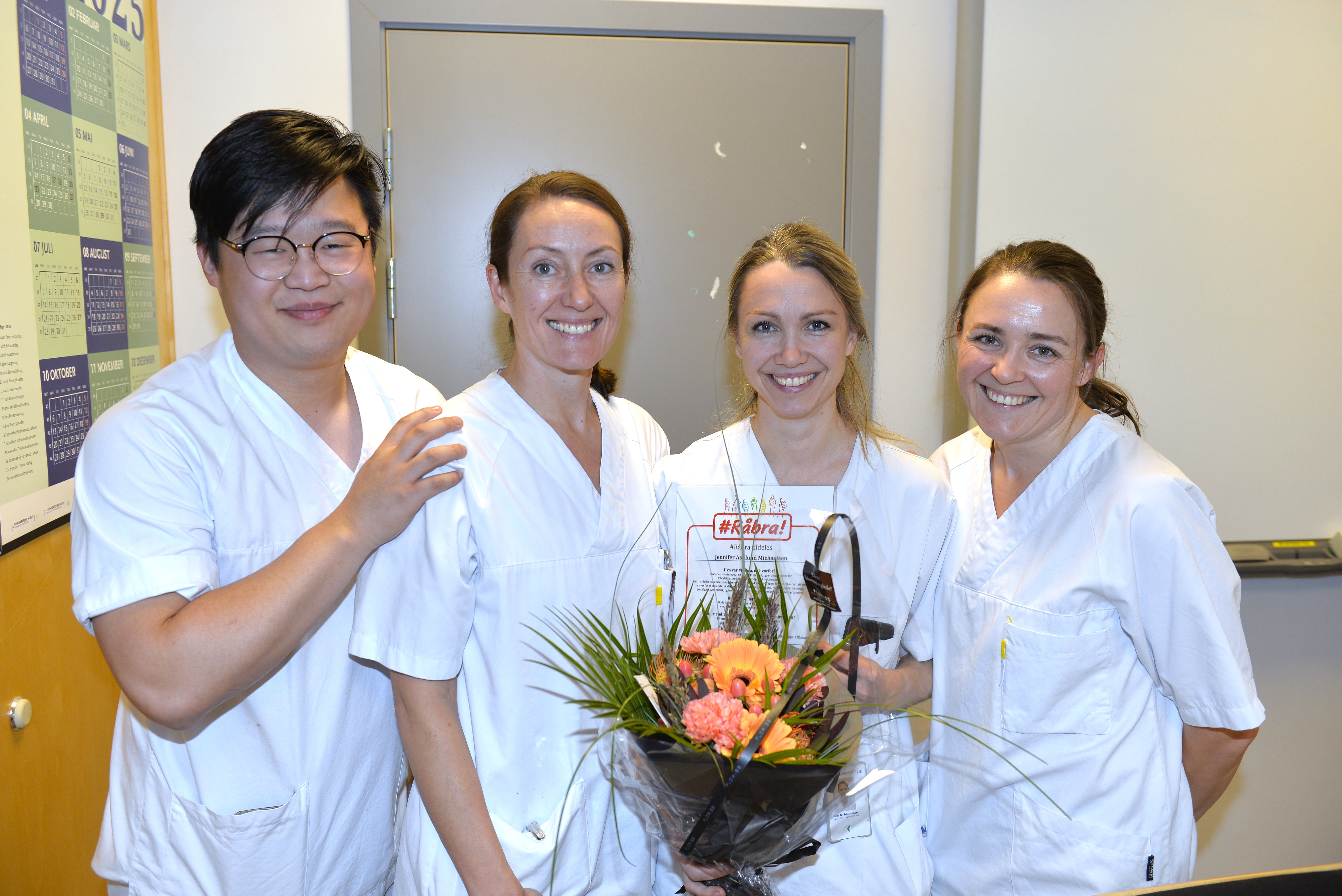 En gruppe i hvite skjorter som holder blomster