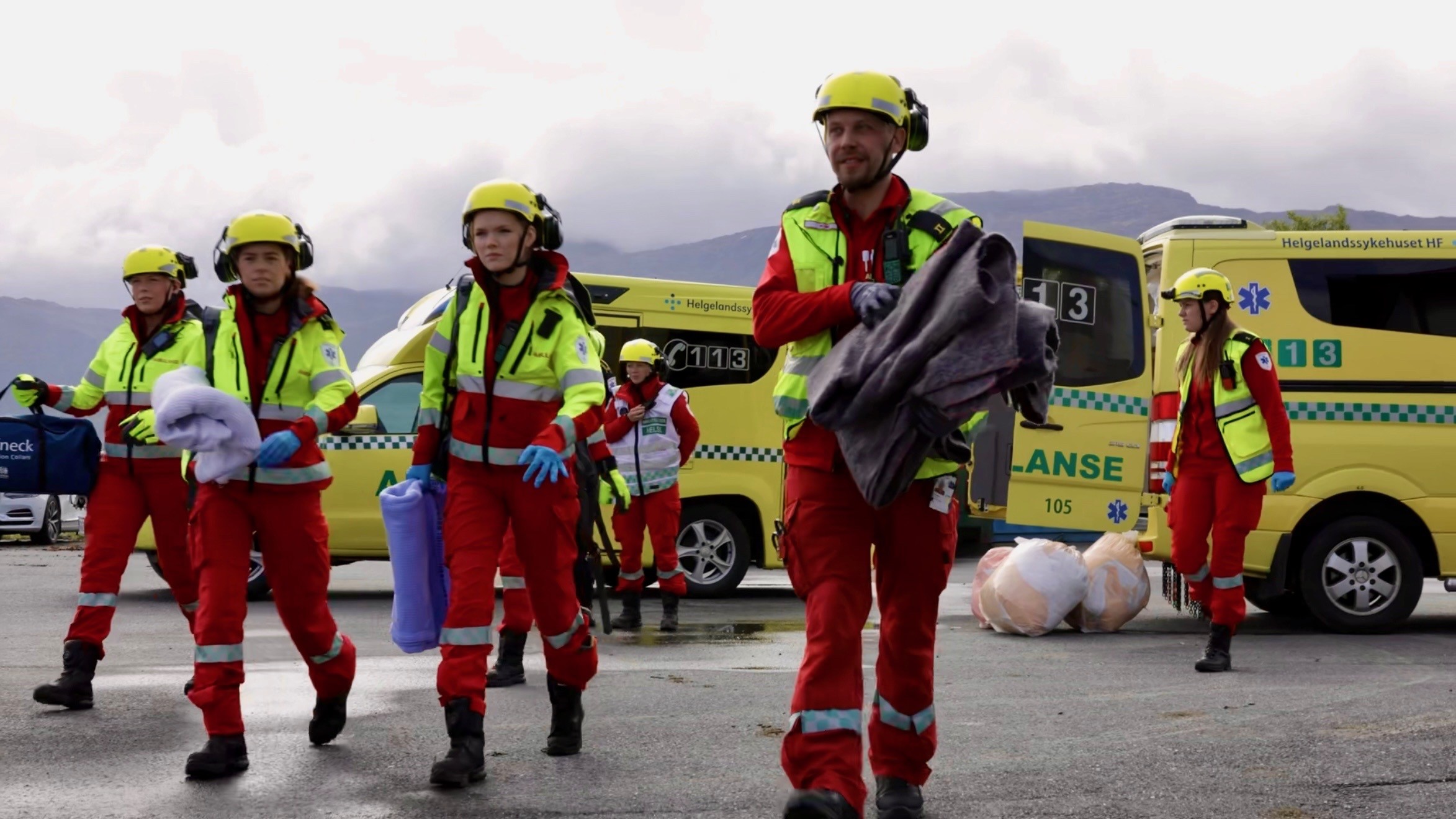 A group of firefighters standing in front of a firetruck
